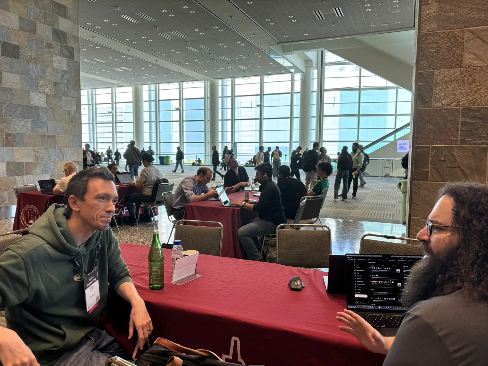 Ahmad M. Osman speaking with an attendee at an AI conference